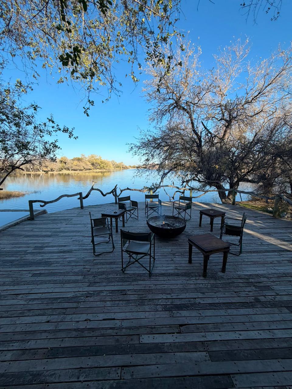 Private seating arranged beside the river at the Botswana camp