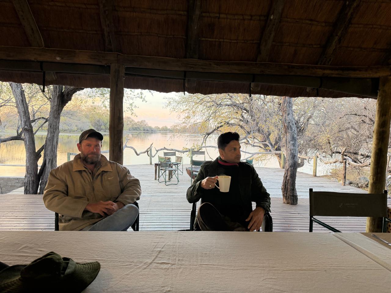 A visiting hunter with a member of the Botswana field team at camp